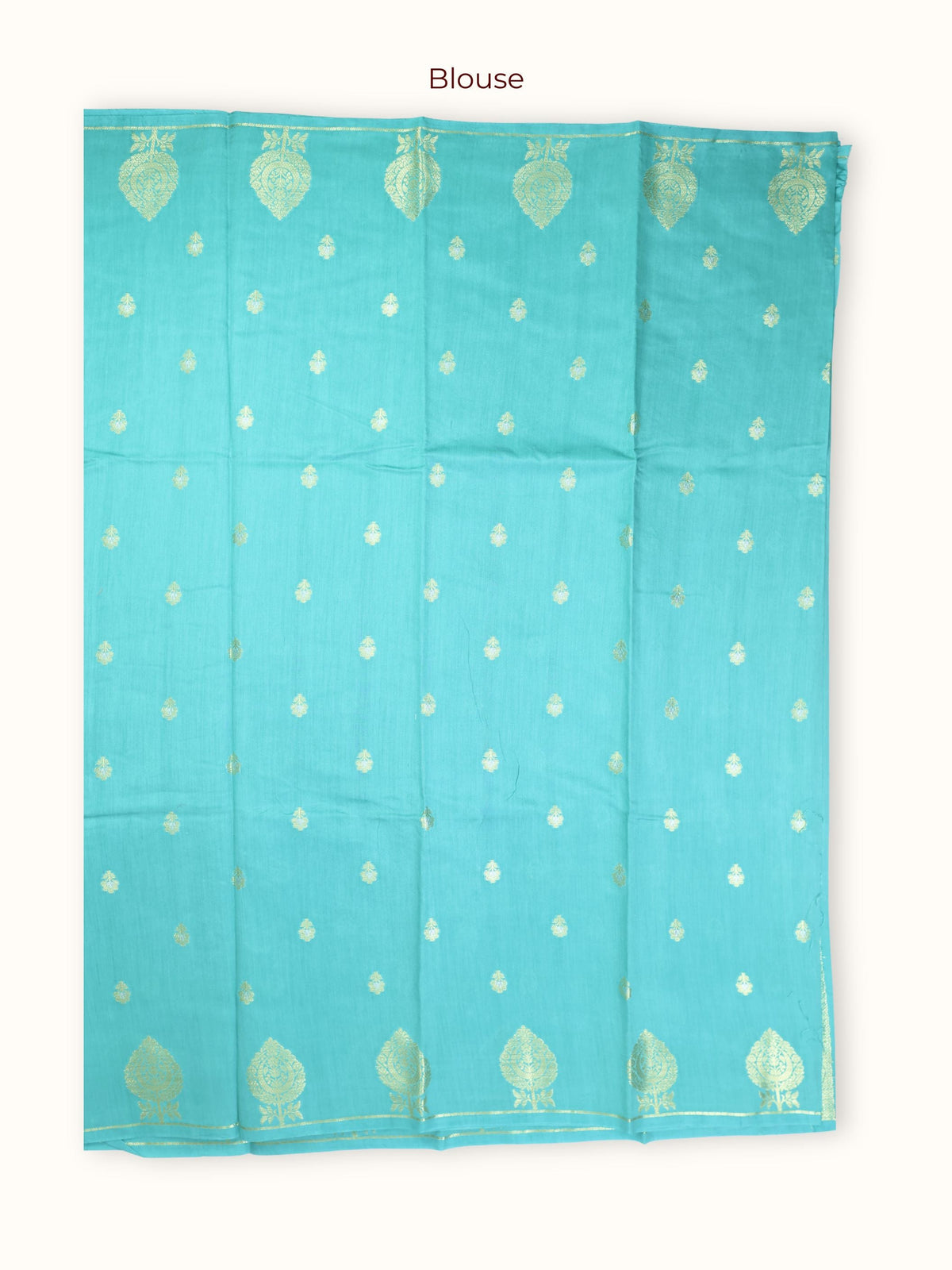 The unstitched blouse piece in turquoise with gold butis