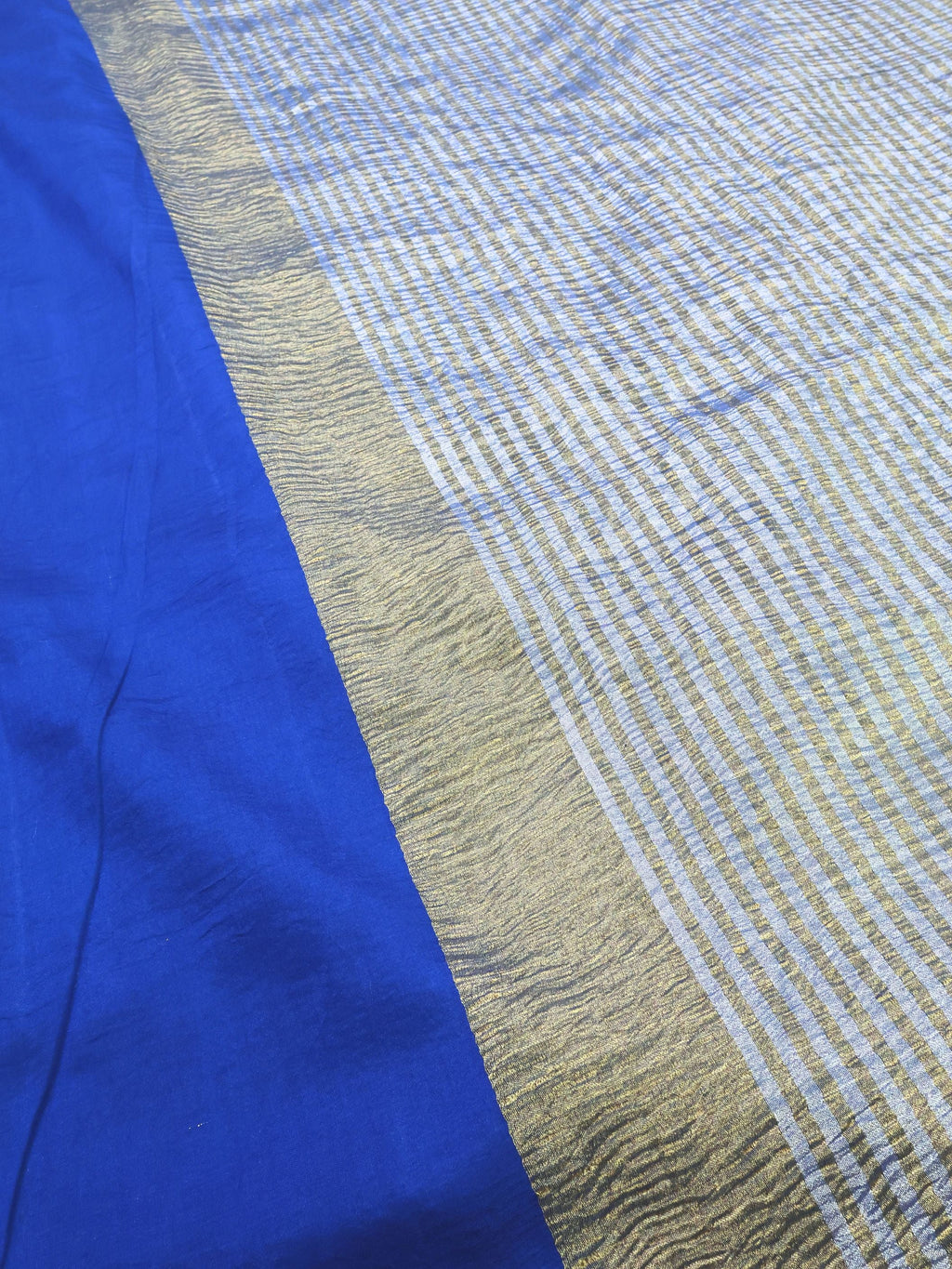 Close detail of the chequered zari against royal blue silk