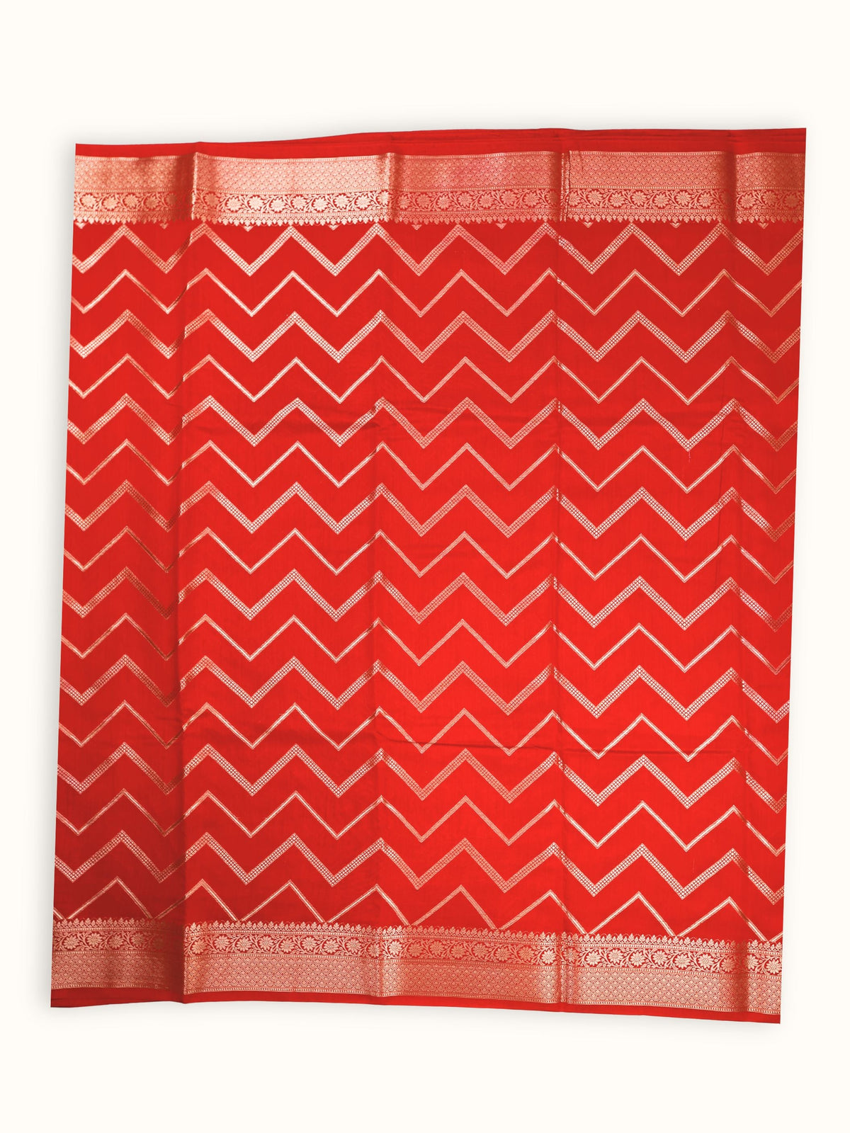 The saree spread flat, silver chevron bands running the width