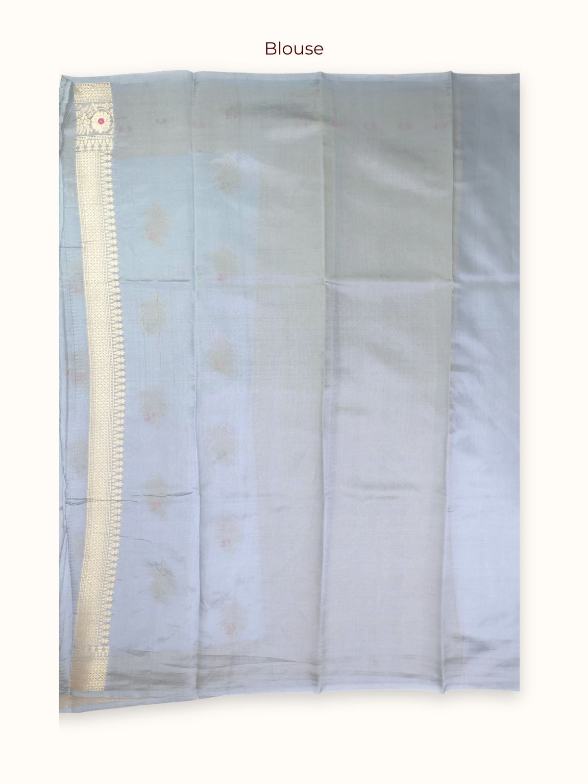 The unstitched blouse piece in powder blue with gold zari