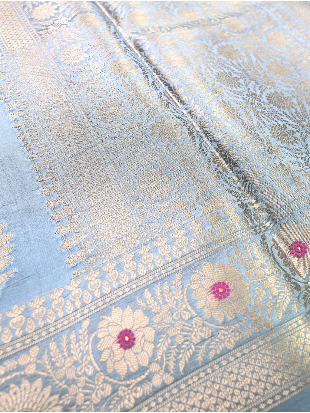 Close detail of the border, gold flowers with pink meena centres