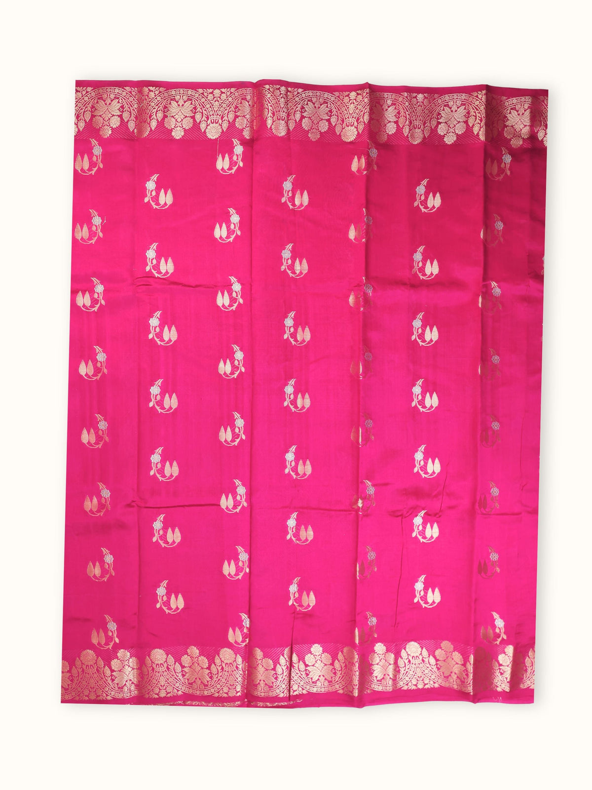 The saree spread flat, silver sprigs scattered across the body