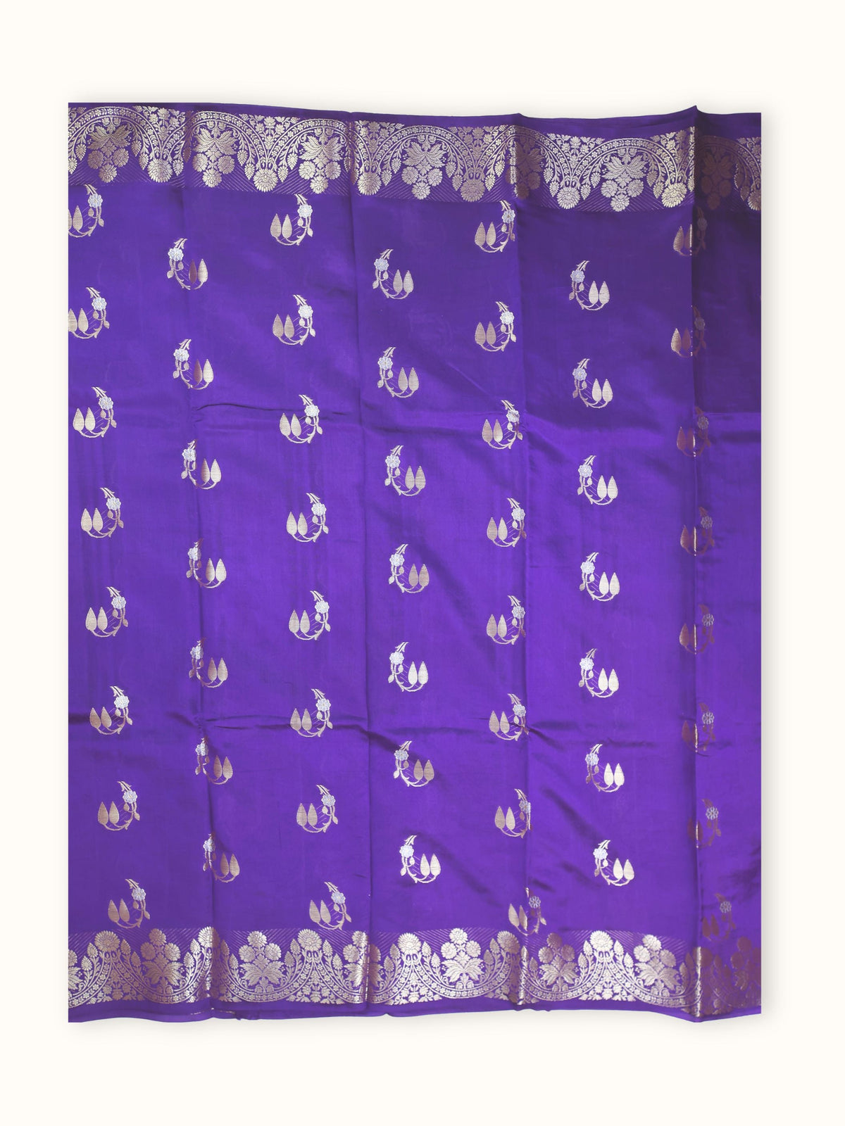 The saree spread flat, silver sprigs scattered across the body