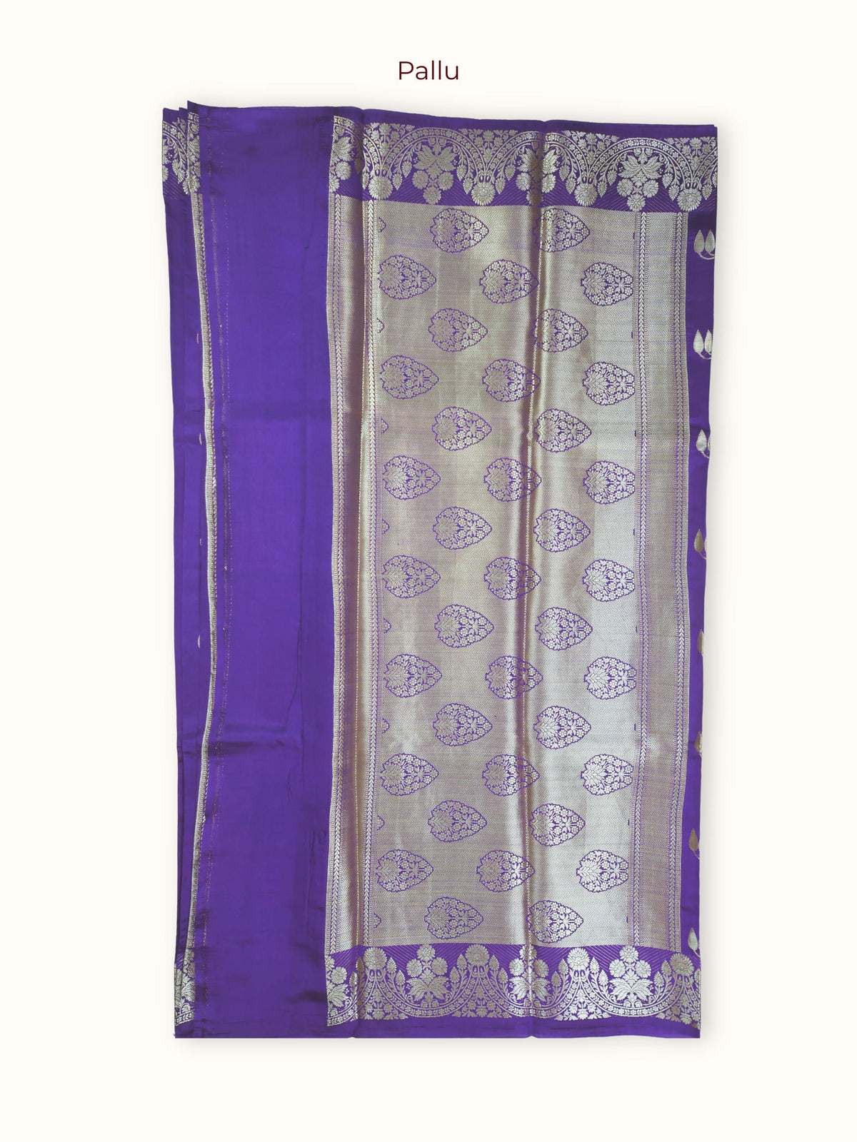 The pallu, large silver paisleys in rows closed with chevrons