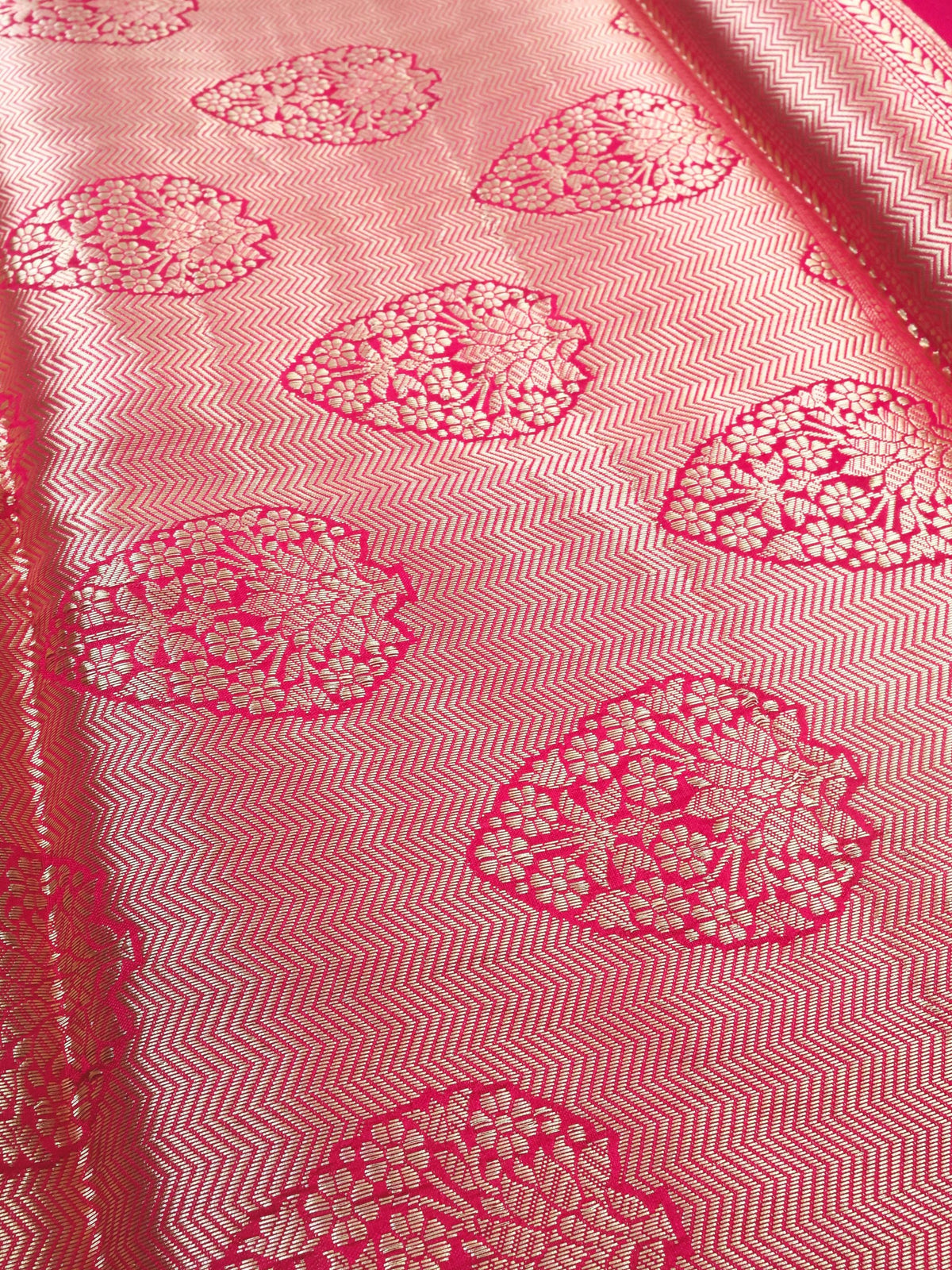 Close detail of the silver paisley work on magenta silk