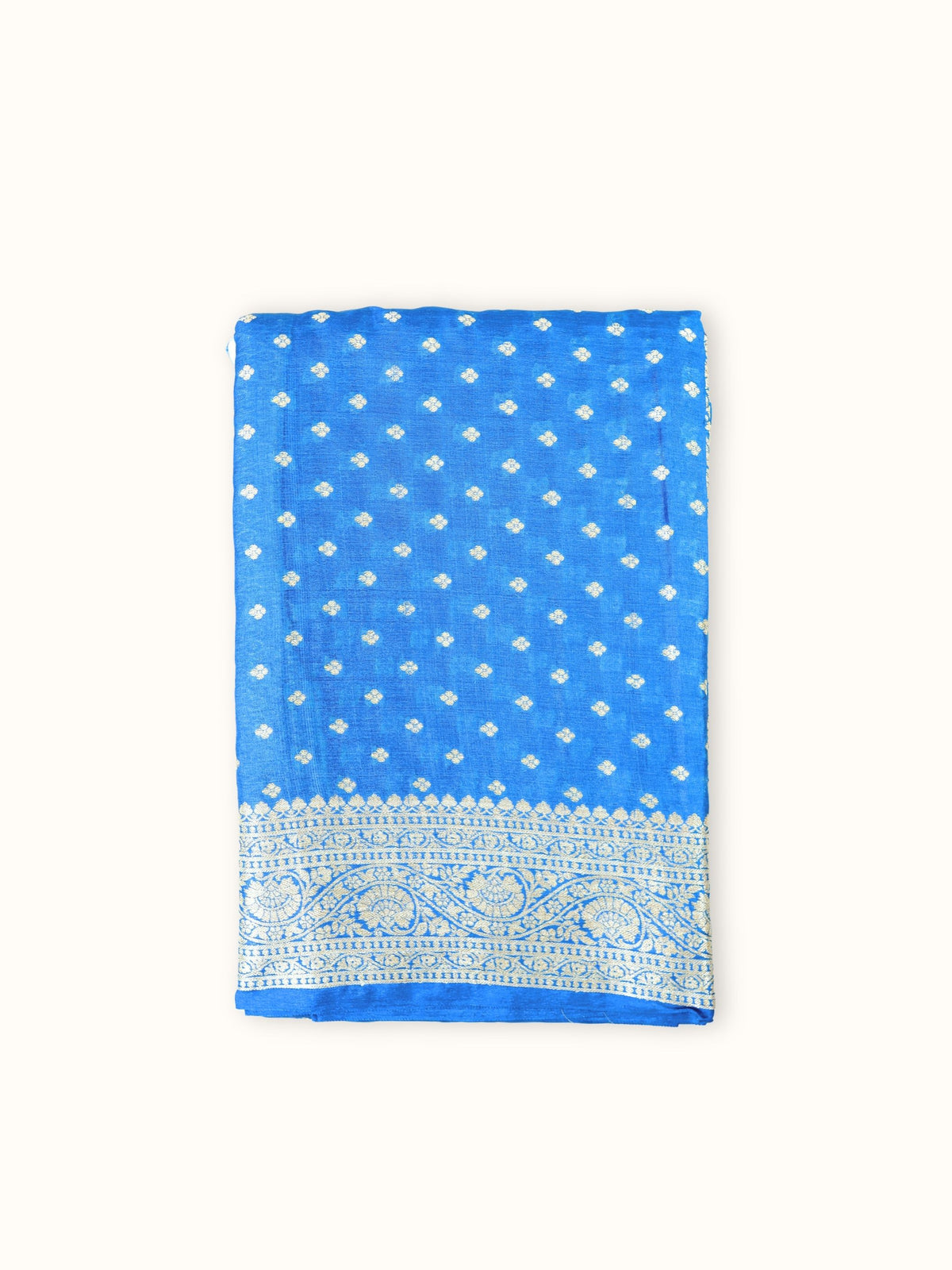 Azure blue Tassar silk saree folded, with small butis and a floral border