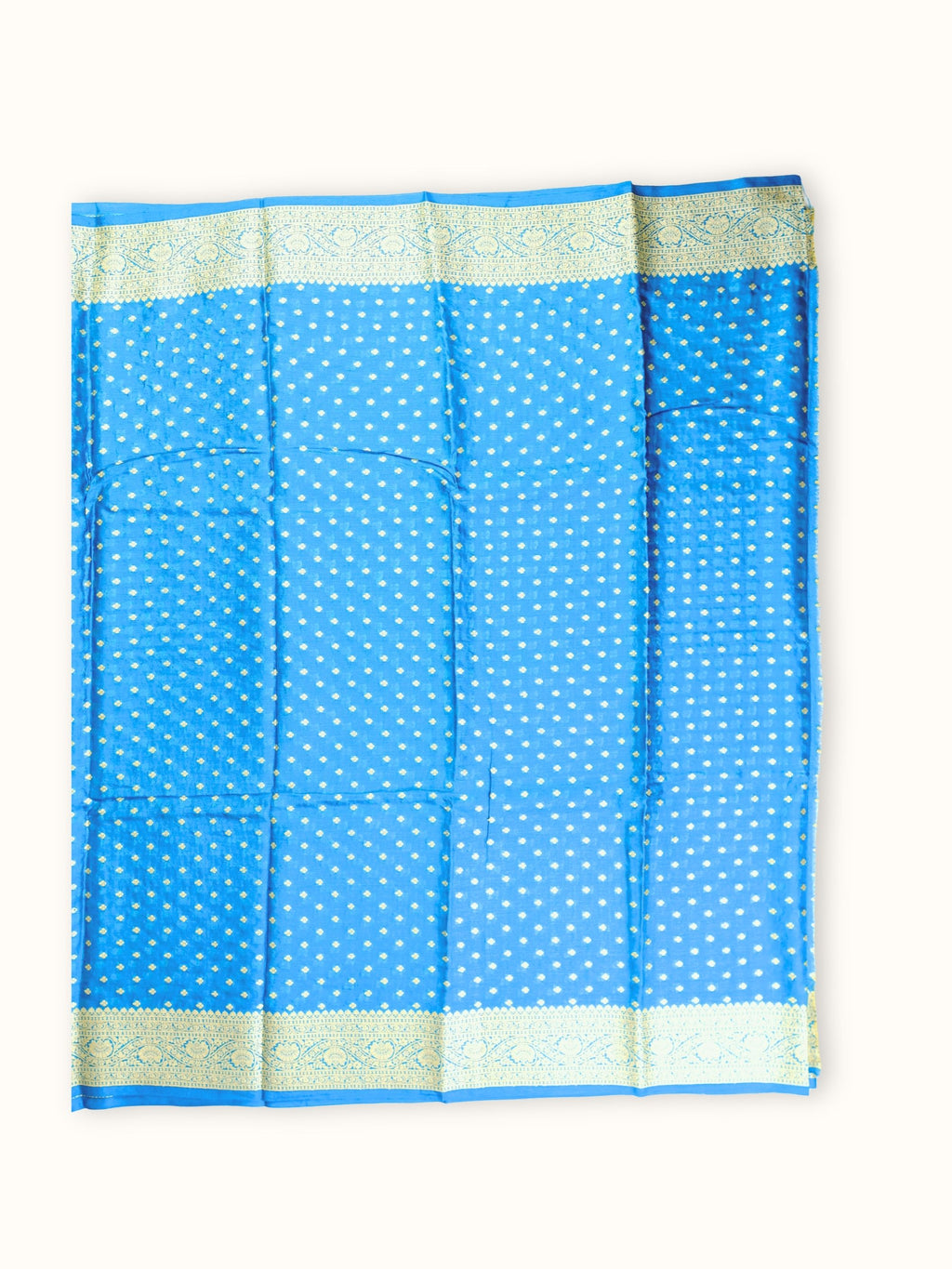 Saree laid open, butis in close rows across the body