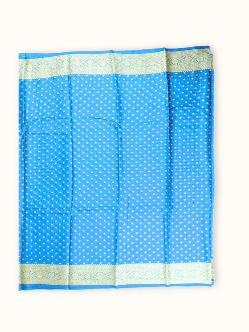 Saree laid open, butis in close rows across the body