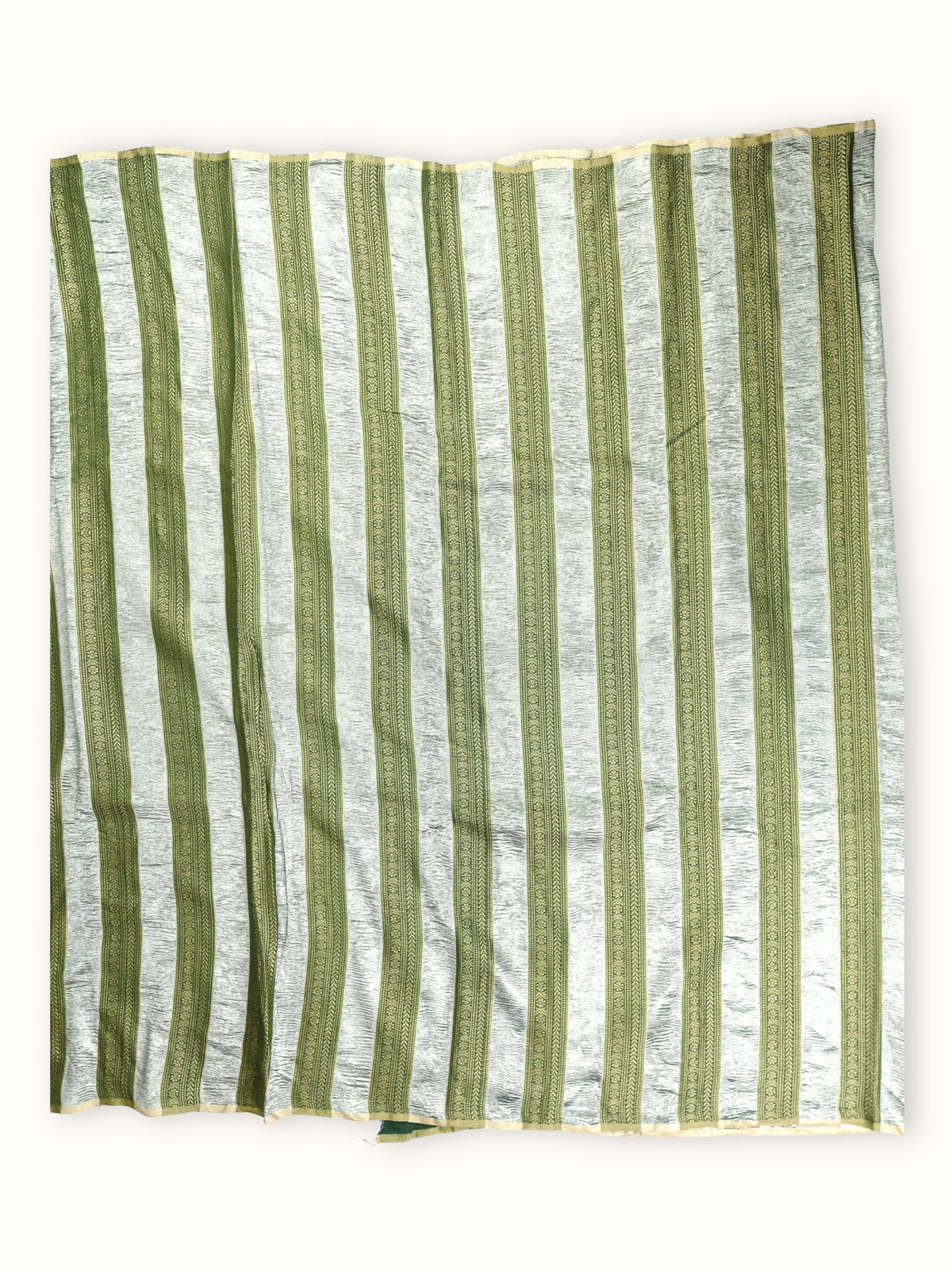 Saree laid open, green and silver stripes down the body