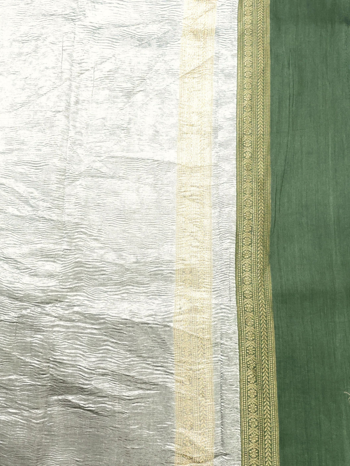 Silver tissue and gold-patterned green band in close detail