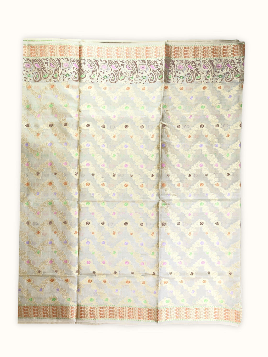 Saree laid open, gold vines and pastel flowers across the body