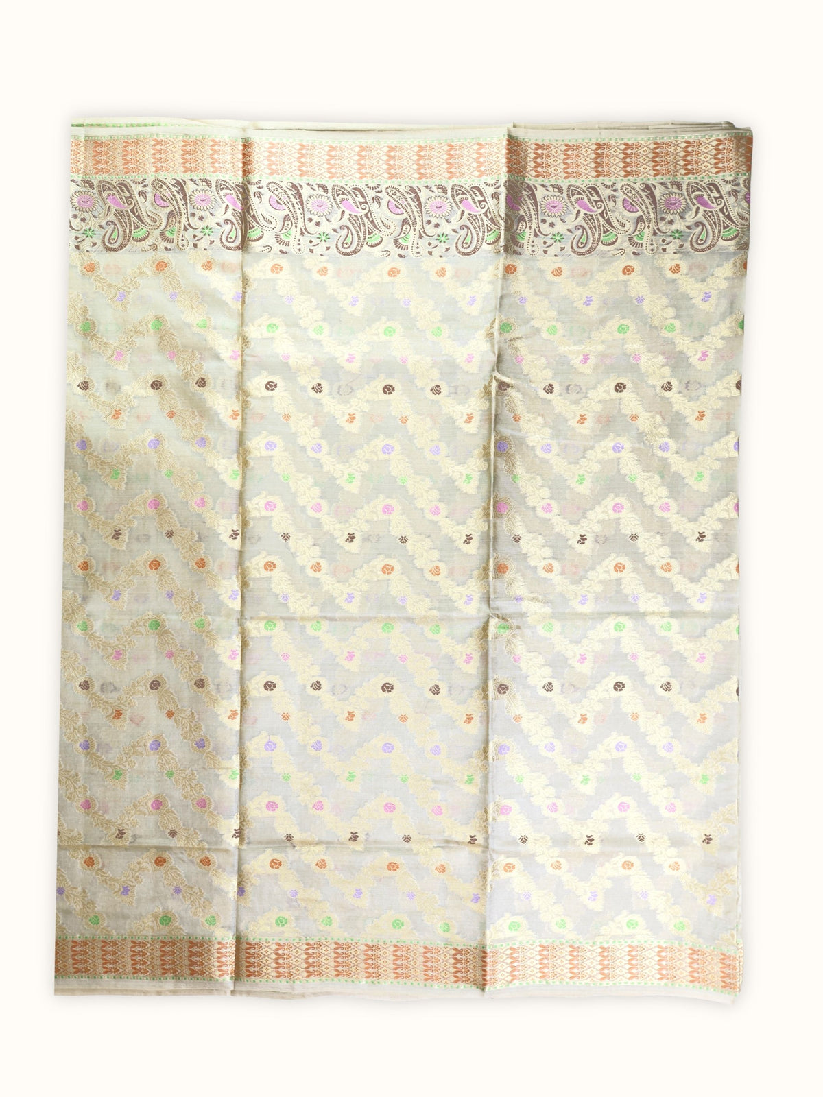 Saree laid open, gold vines and pastel flowers across the body