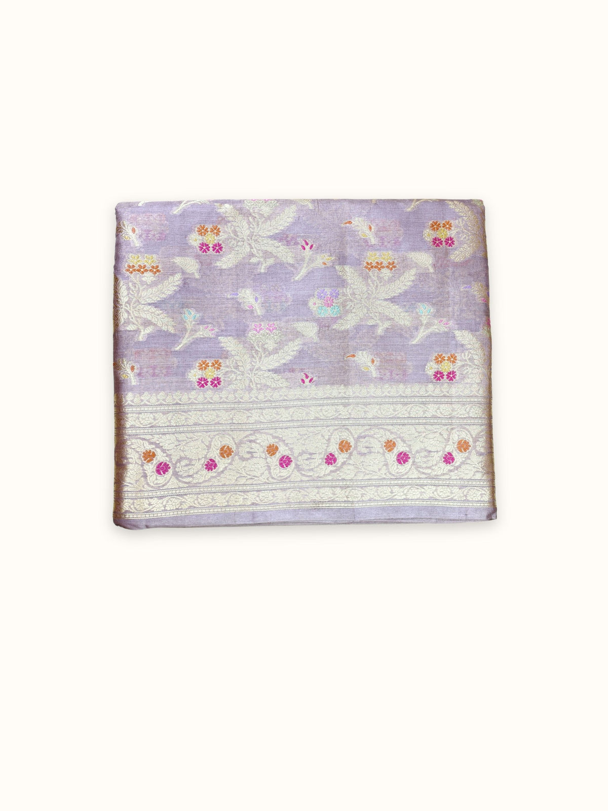 Lilac Tassar silk saree folded, with gold leaf sprays and a floral border