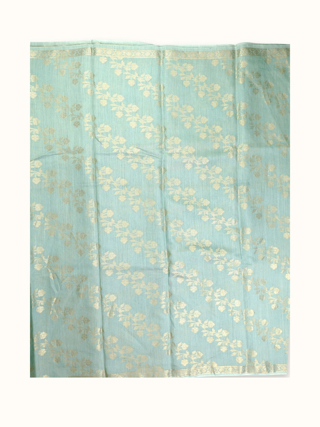 Saree laid open, gold sprays in diagonal rows
