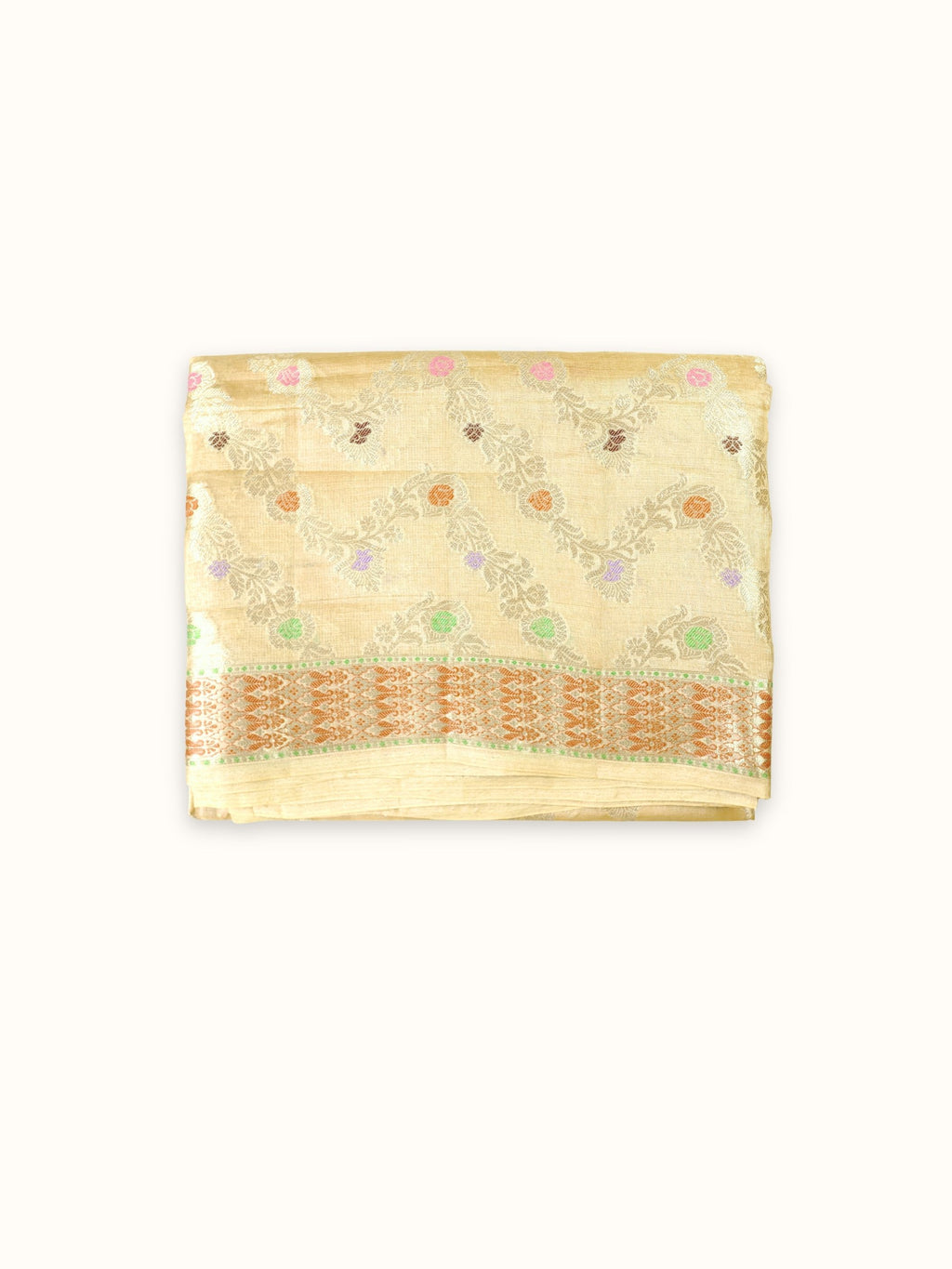 Pale gold Tassar silk saree folded, with zigzag vines and a copper border