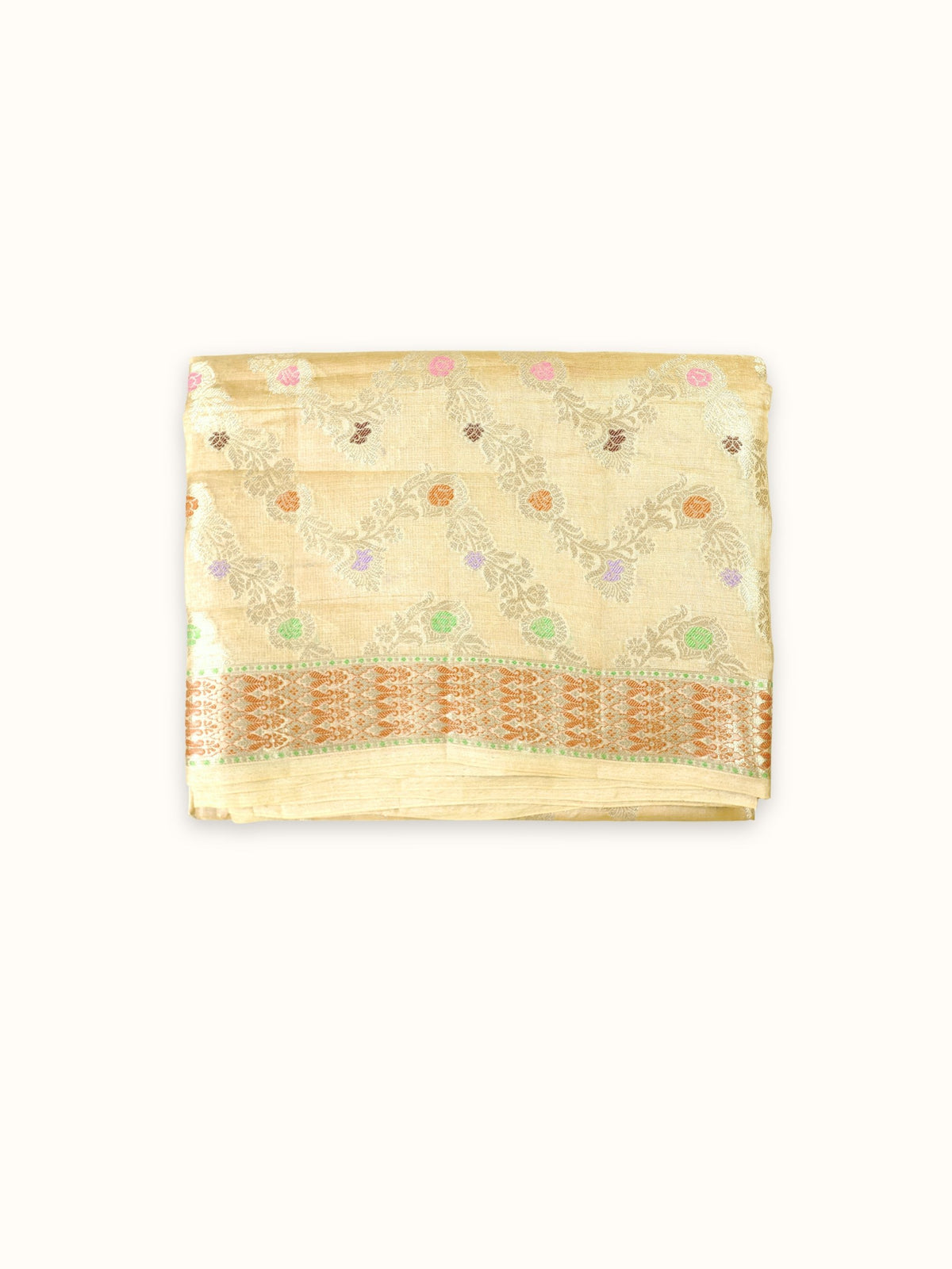 Pale gold Tassar silk saree folded, with zigzag vines and a copper border