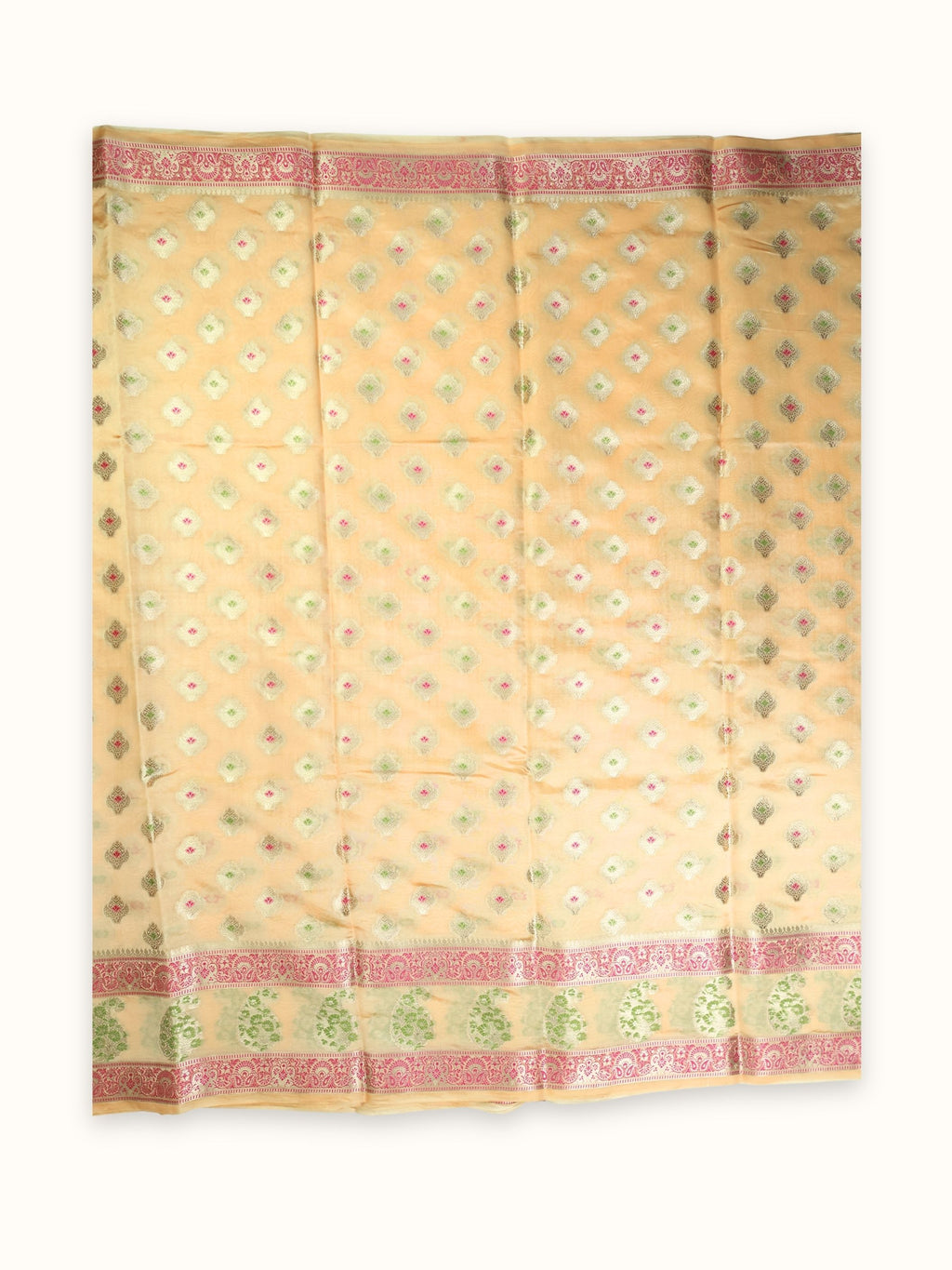 Saree laid open, pink and green butis across the body