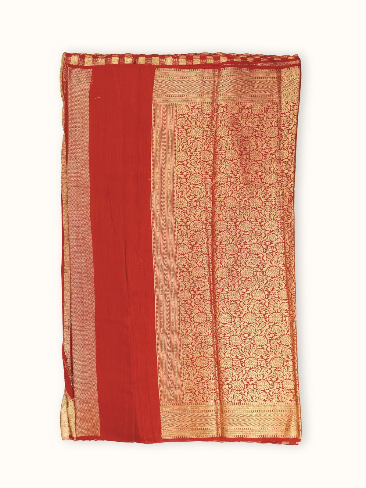 Pallu of dense gold florals beside a plain red panel