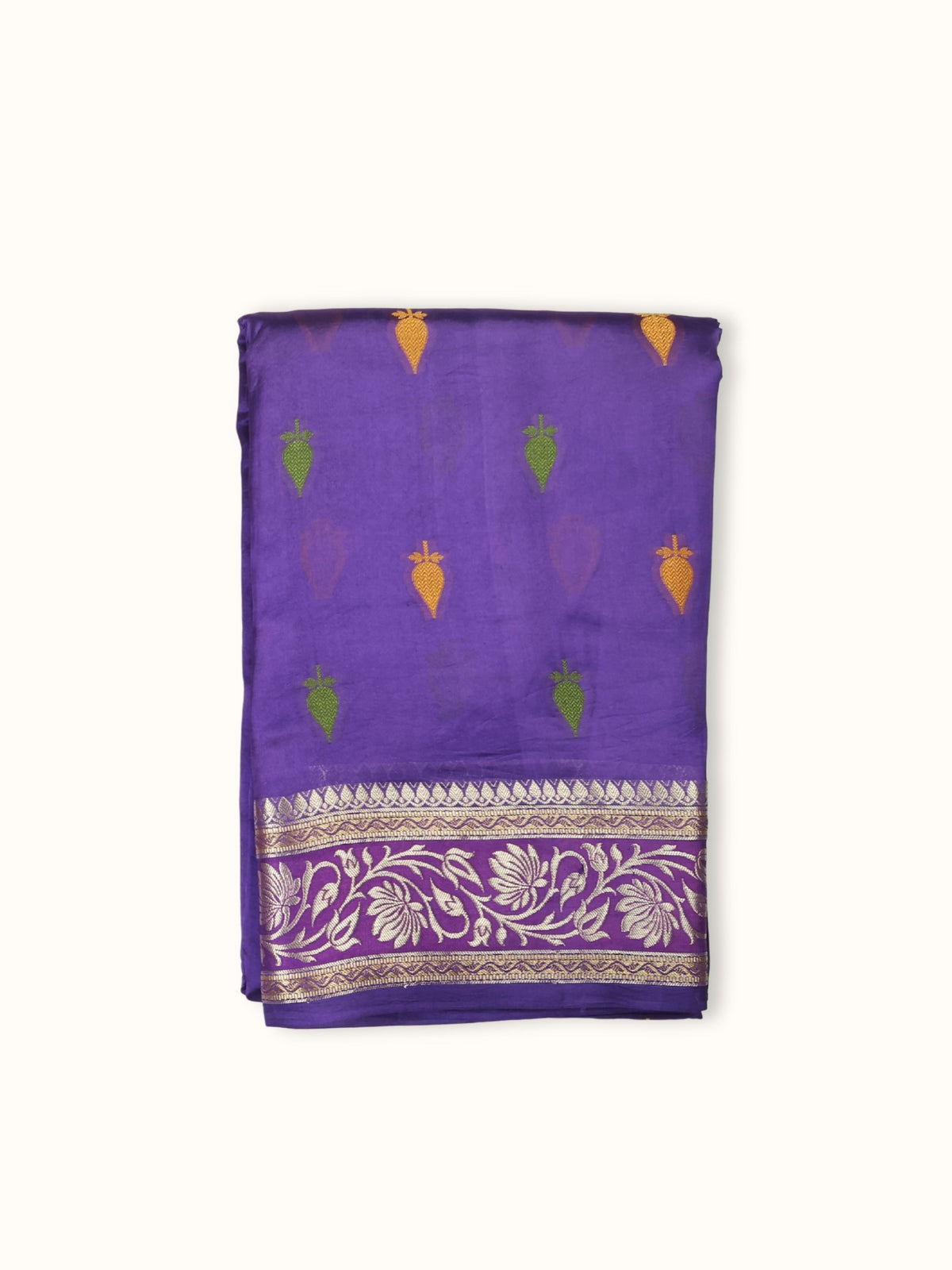 Royal purple Dupian silk saree folded, with green and gold butis and a lotus border
