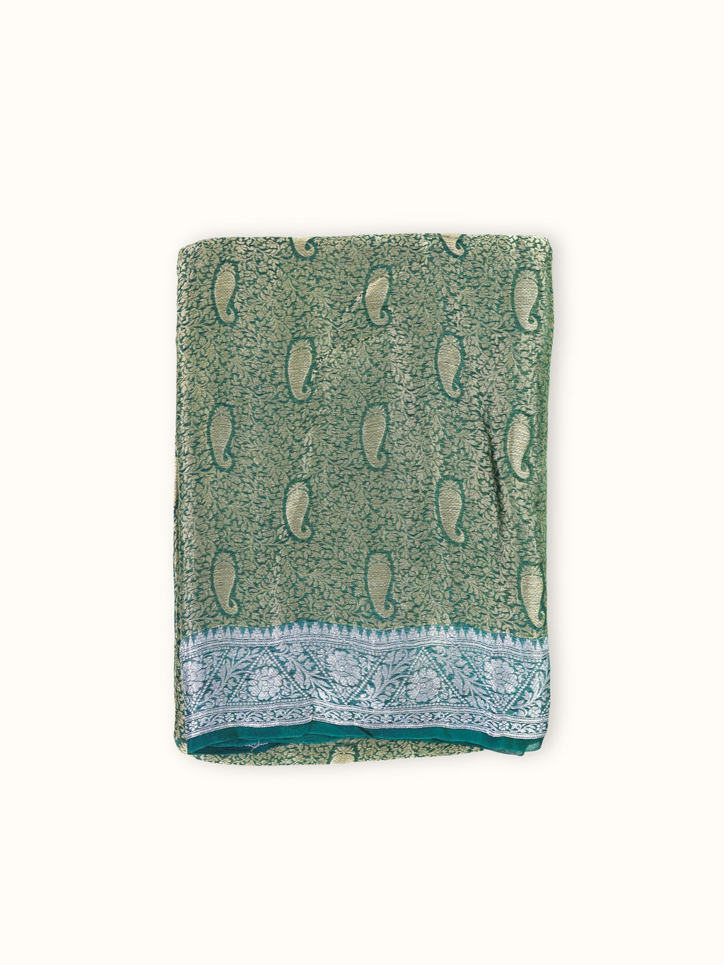 Teal green chiffon brocade saree folded, with gold paisleys and a silver border